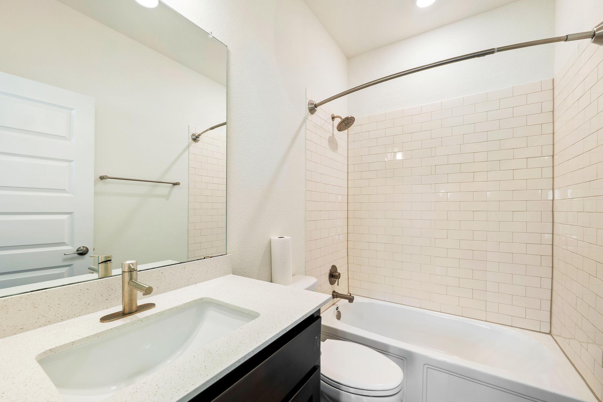 306 Cartwheel Bend, Unit 130 Austin, TX 78738 - Photo 35 of 40 a bathroom with a sink and a mirror