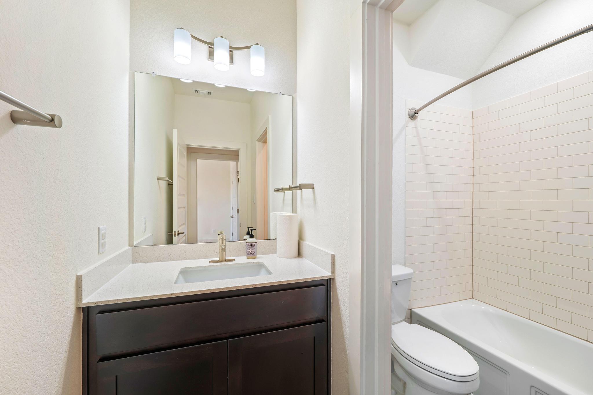 306 Cartwheel Bend, Unit 130 Austin, TX 78738 - Photo 36 of 40 a bathroom with a sink toilet and shower