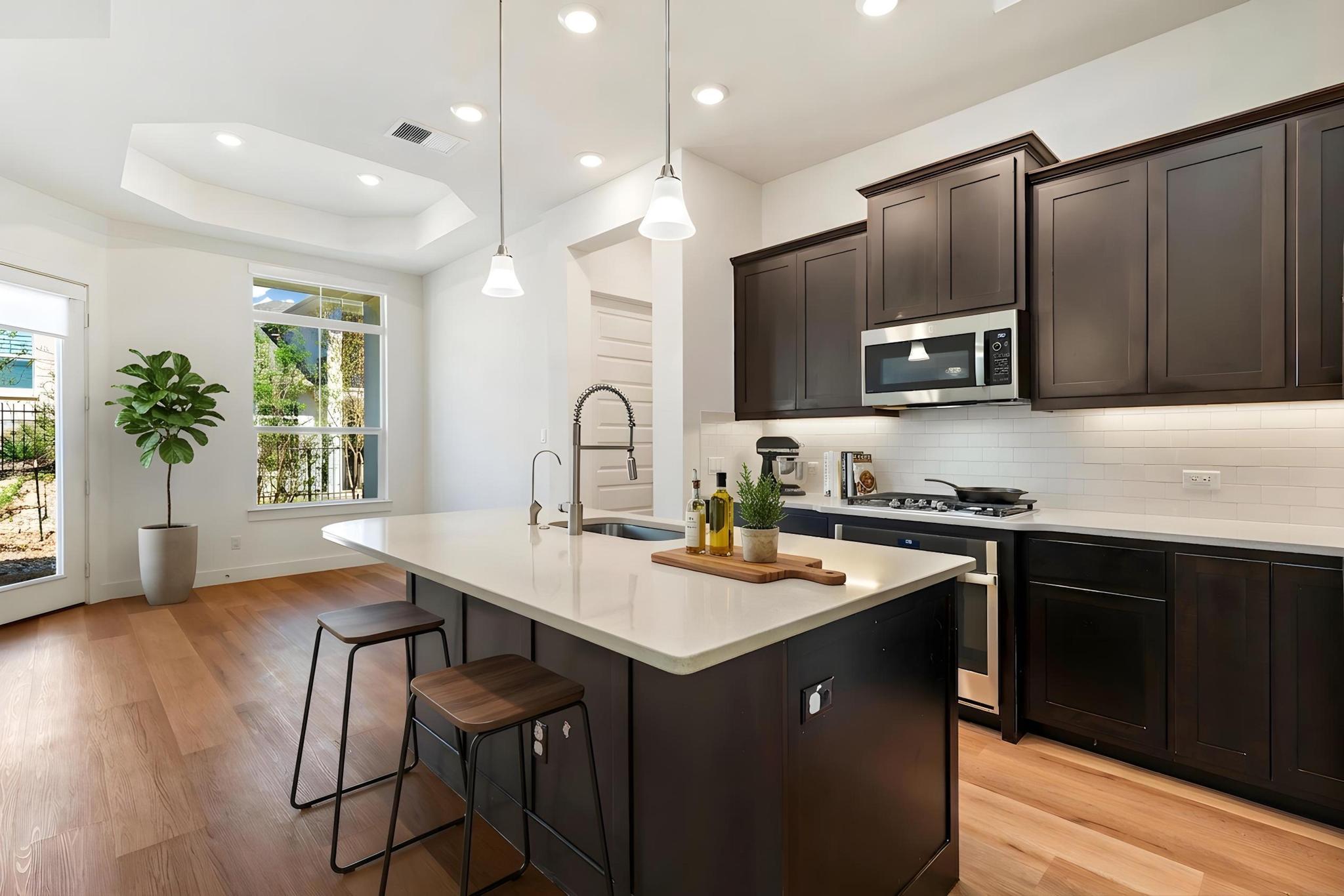 306 Cartwheel Bend, Unit 130 Austin, TX 78738 - Photo 7 of 40 a kitchen with a sink cabinets and wooden floor