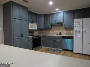 6662 Goodall Mill Road Macon, GA 31216 - Photo 19 of 50 a kitchen with granite countertop wooden cabinets and refrigerator