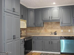 6662 Goodall Mill Road Macon, GA 31216 - Photo 21 of 50 a kitchen with stainless steel appliances granite countertop a sink stove and cabinets