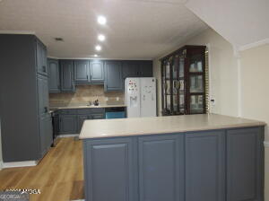 6662 Goodall Mill Road Macon, GA 31216 - Photo 22 of 50 a kitchen with kitchen island a sink stainless steel appliances and cabinets
