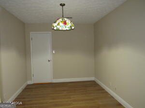 6662 Goodall Mill Road Macon, GA 31216 - Photo 30 of 50 a view of an empty room with wooden floor and chandelier