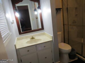 6662 Goodall Mill Road Macon, GA 31216 - Photo 33 of 50 a bathroom with a sink a toilet a mirror and vanity