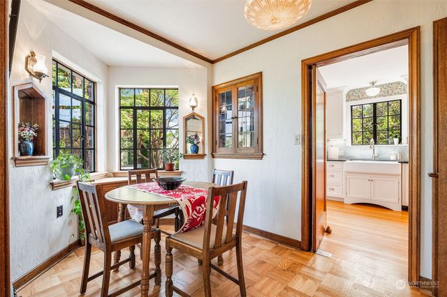 a dining room with furniture and large windows