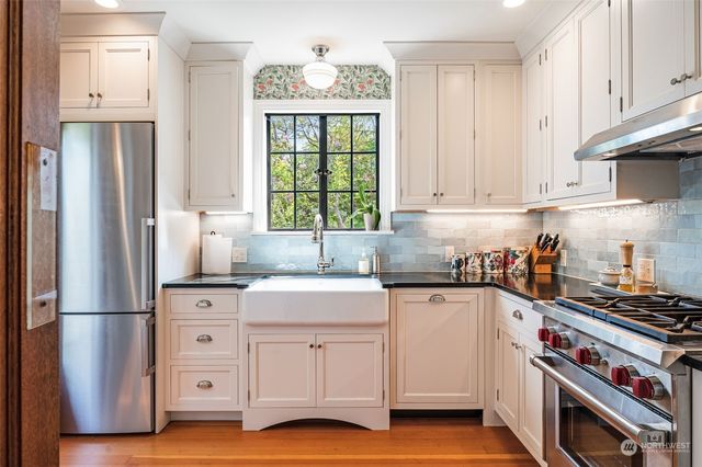 a kitchen with white cabinets and white appliances