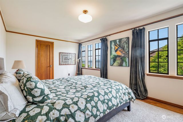 a bedroom with a large bed and a large window