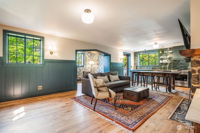 a living room with furniture and a floor to ceiling window