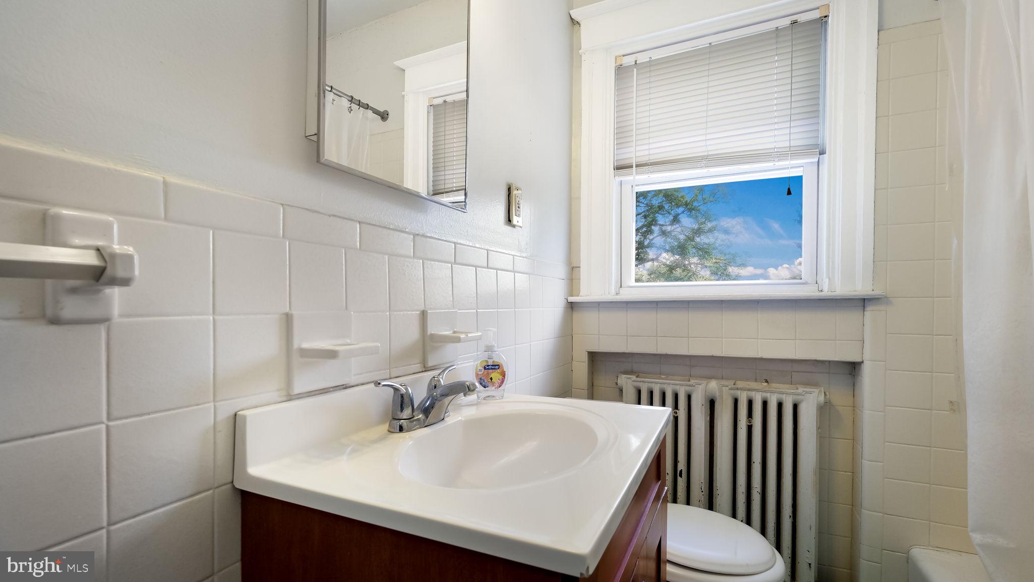 271 Ballymore Road Springfield, PA 19064 - Photo 15 of 21 a bathroom with a sink toilet and a mirror