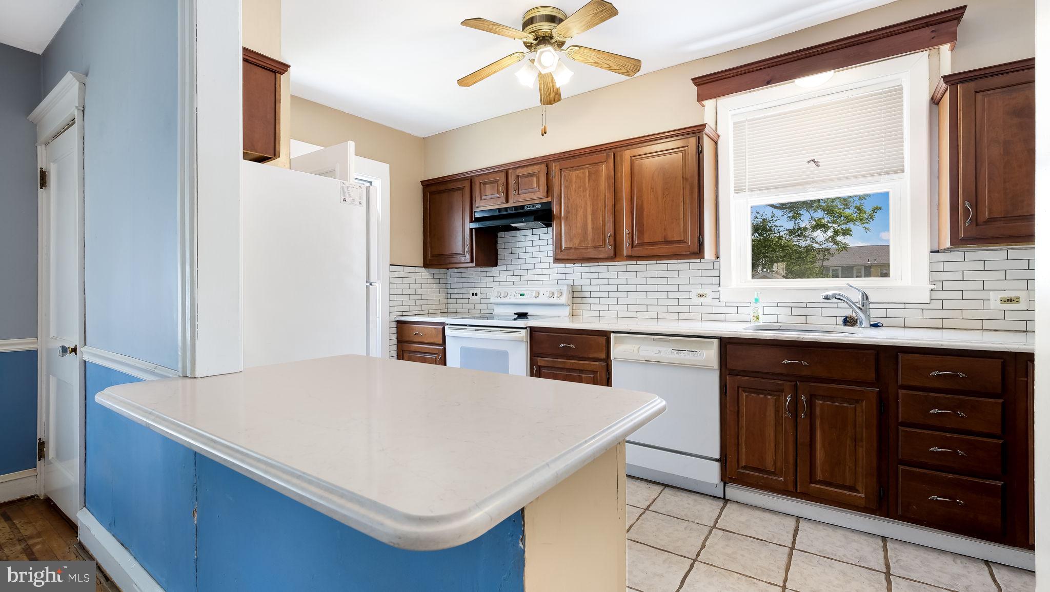 271 Ballymore Road Springfield, PA 19064 - Photo 9 of 21 a kitchen with a sink a stove and a refrigerator