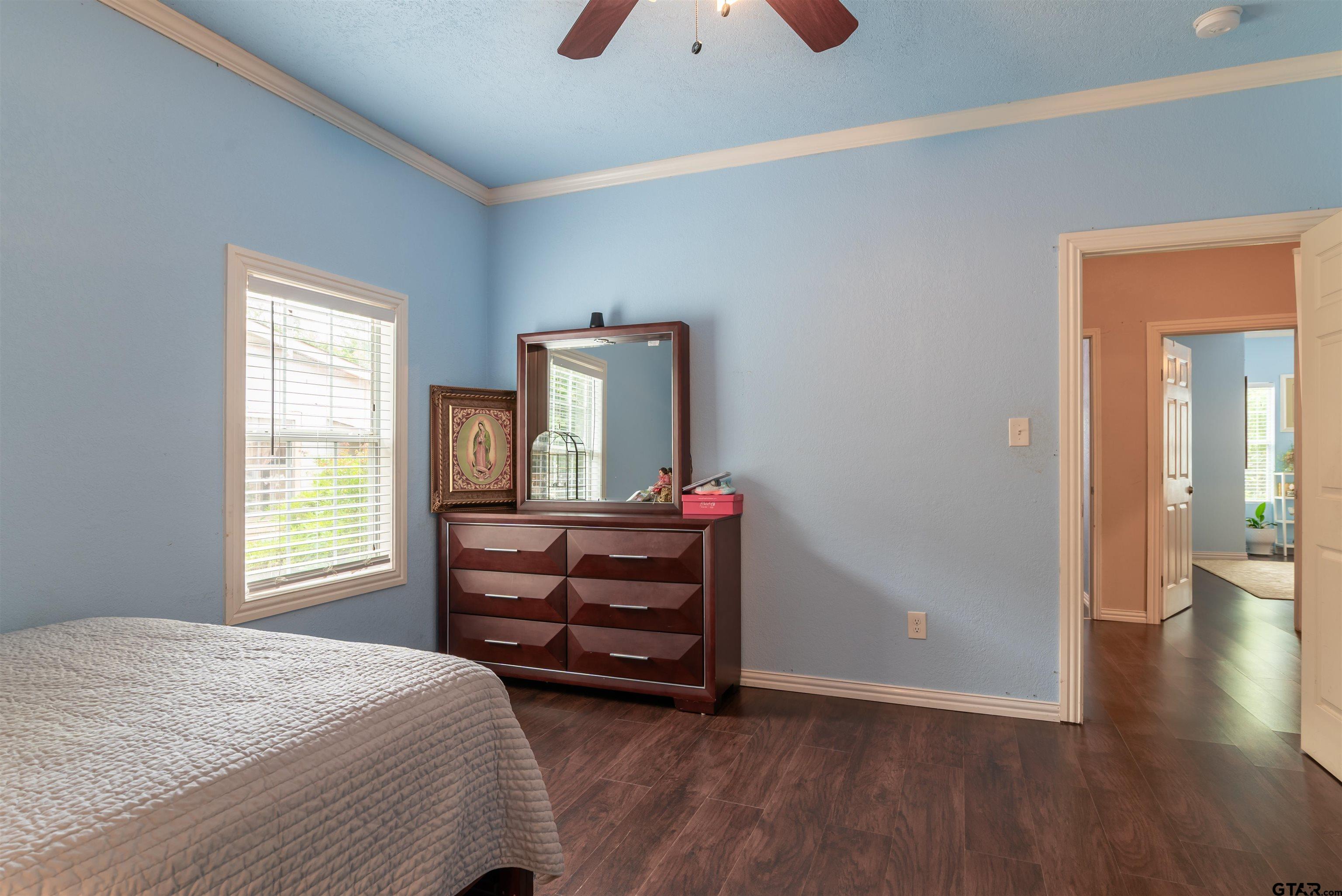 427 East Locust Street Tyler, TX 75702 - Photo 25 of 42 a bedroom with a bed and wooden floor