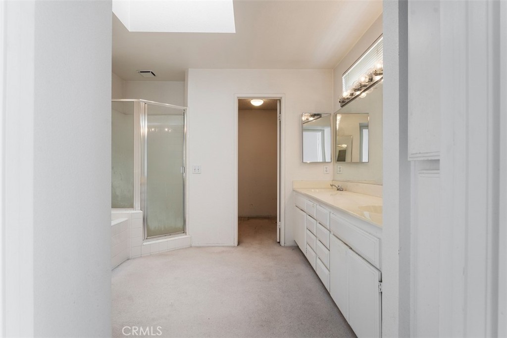 7040 Marino Place Rancho Cucamonga, CA 91701 - Photo 21 of 45 a bathroom with a granite countertop sink and a bathtub