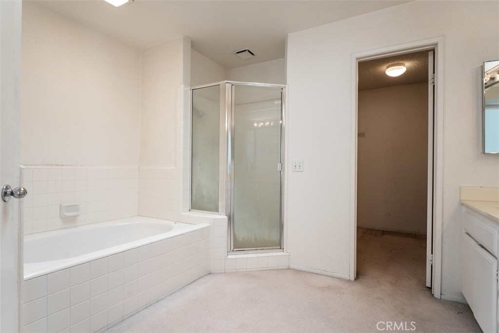 7040 Marino Place Rancho Cucamonga, CA 91701 - Photo 22 of 45 a bathroom with a bathtub and a shower