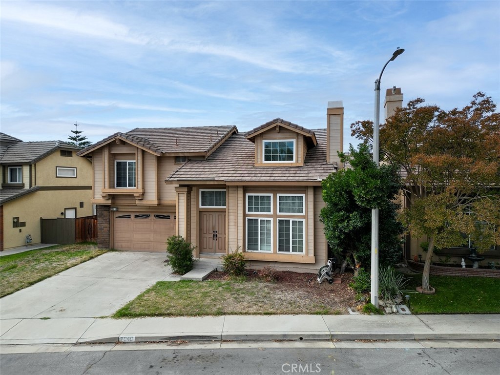 7040 Marino Place Rancho Cucamonga, CA 91701 - Photo 3 of 45 a front view of a house with a yard and garage