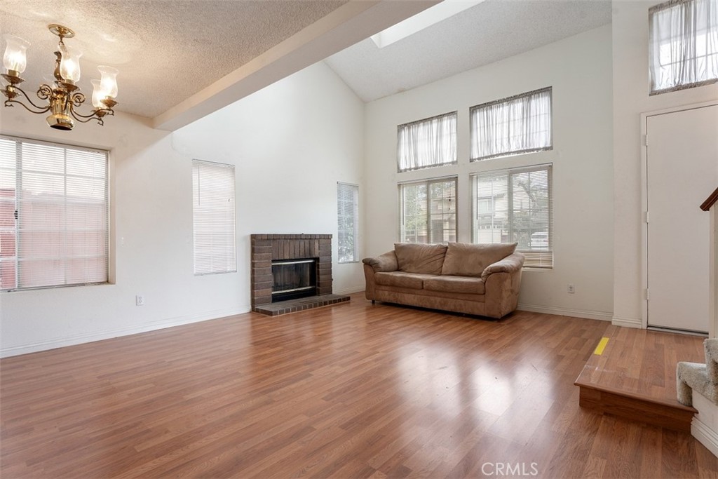 7040 Marino Place Rancho Cucamonga, CA 91701 - Photo 6 of 45 a living room with furniture and wooden floor