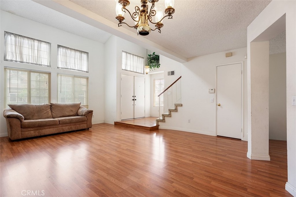 7040 Marino Place Rancho Cucamonga, CA 91701 - Photo 7 of 45 a view of a livingroom with wooden floor and a ceiling fan