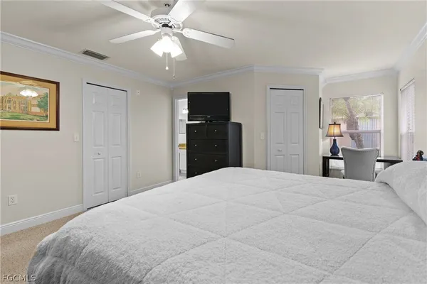 a bedroom with a bed and a ceiling fan