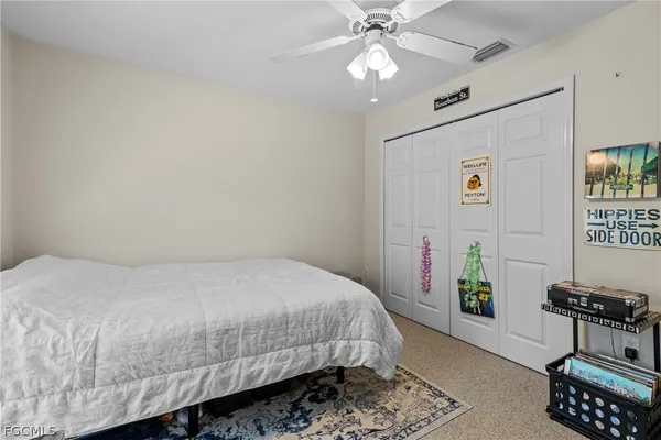 a bedroom with a bed table and chair