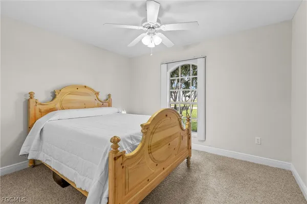 a bedroom with a bed and ceiling fan