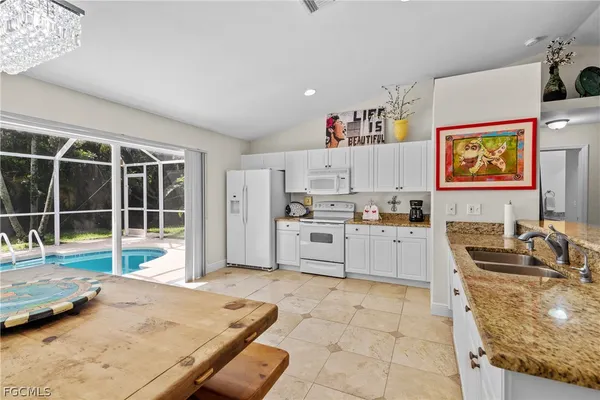 a kitchen with stainless steel appliances granite countertop a stove and a sink with cabinets