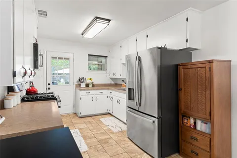 a kitchen with a refrigerator and a sink