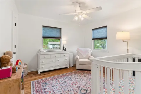 a bedroom with a baby bed baby crib and a window