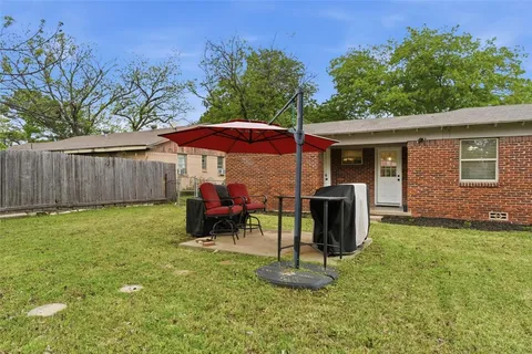 a backyard of a house with table and chairs