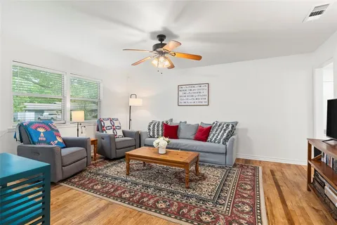 a living room with furniture and a rug