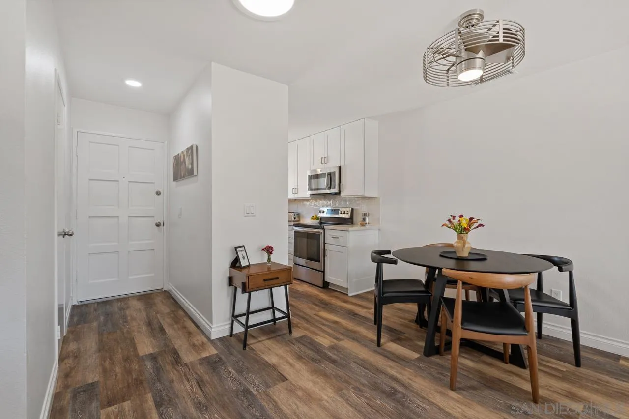 1628 Forestdale Drive Encinitas, CA 92024 - Photo 11 of 39 a dining room with wooden floor a chandelier a wooden table and chairs