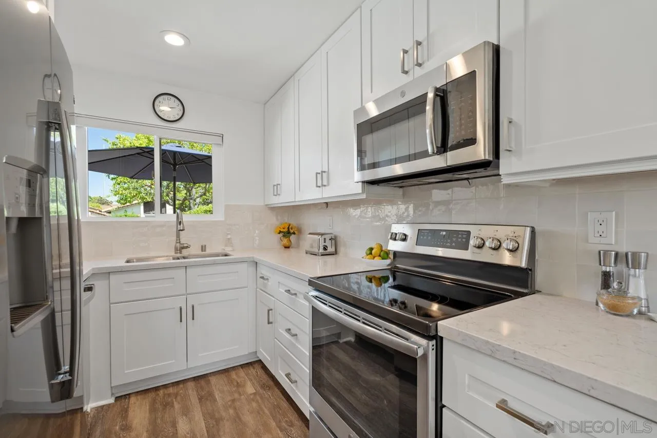 1628 Forestdale Drive Encinitas, CA 92024 - Photo 14 of 39 a kitchen with a stove a sink and a microwave