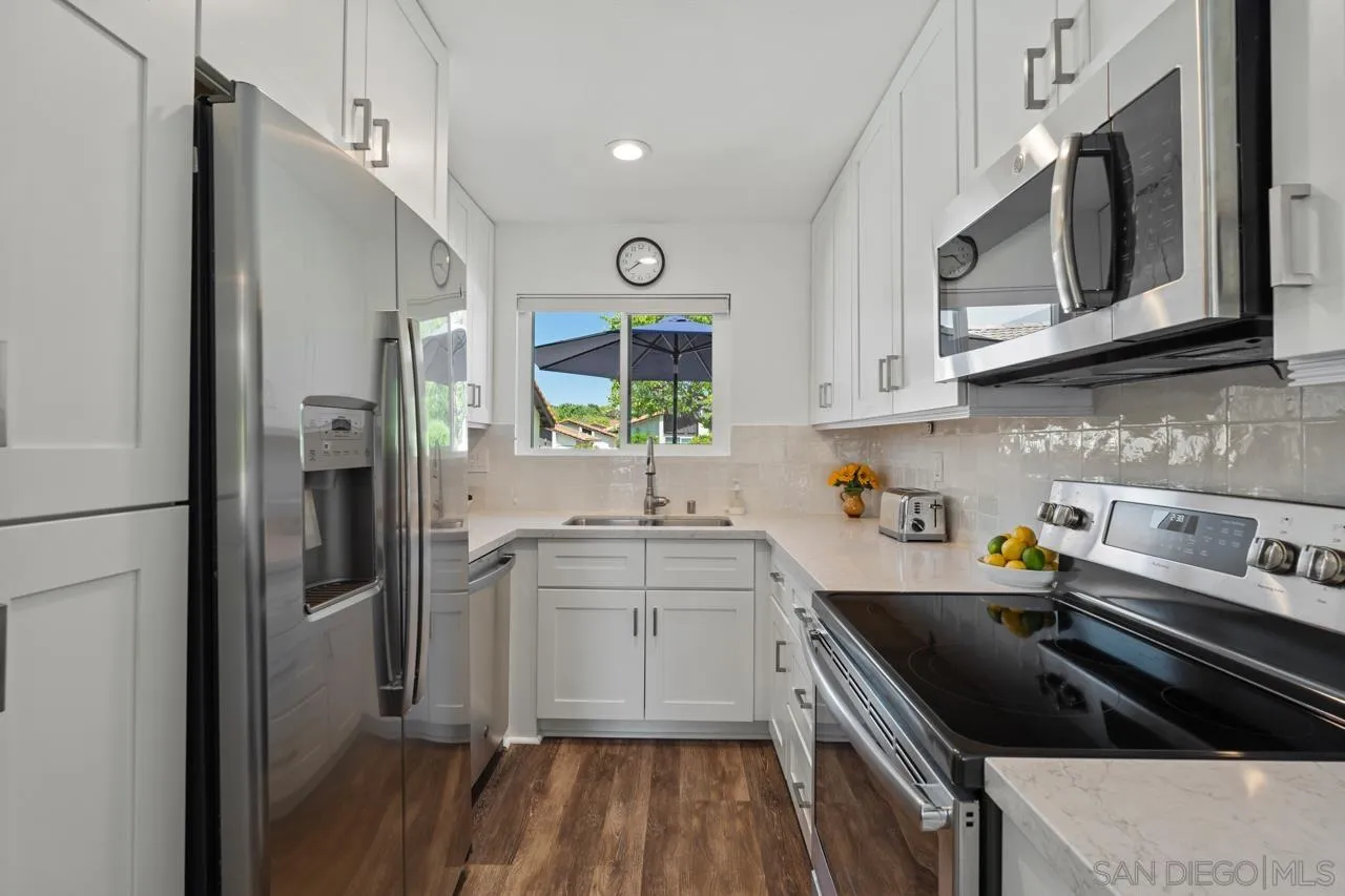 1628 Forestdale Drive Encinitas, CA 92024 - Photo 15 of 39 a kitchen with stainless steel appliances a stove a sink and a refrigerator