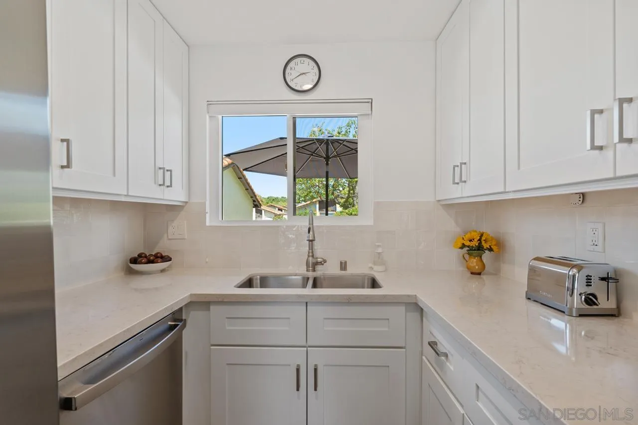 1628 Forestdale Drive Encinitas, CA 92024 - Photo 16 of 39 a kitchen with a sink cabinets and window