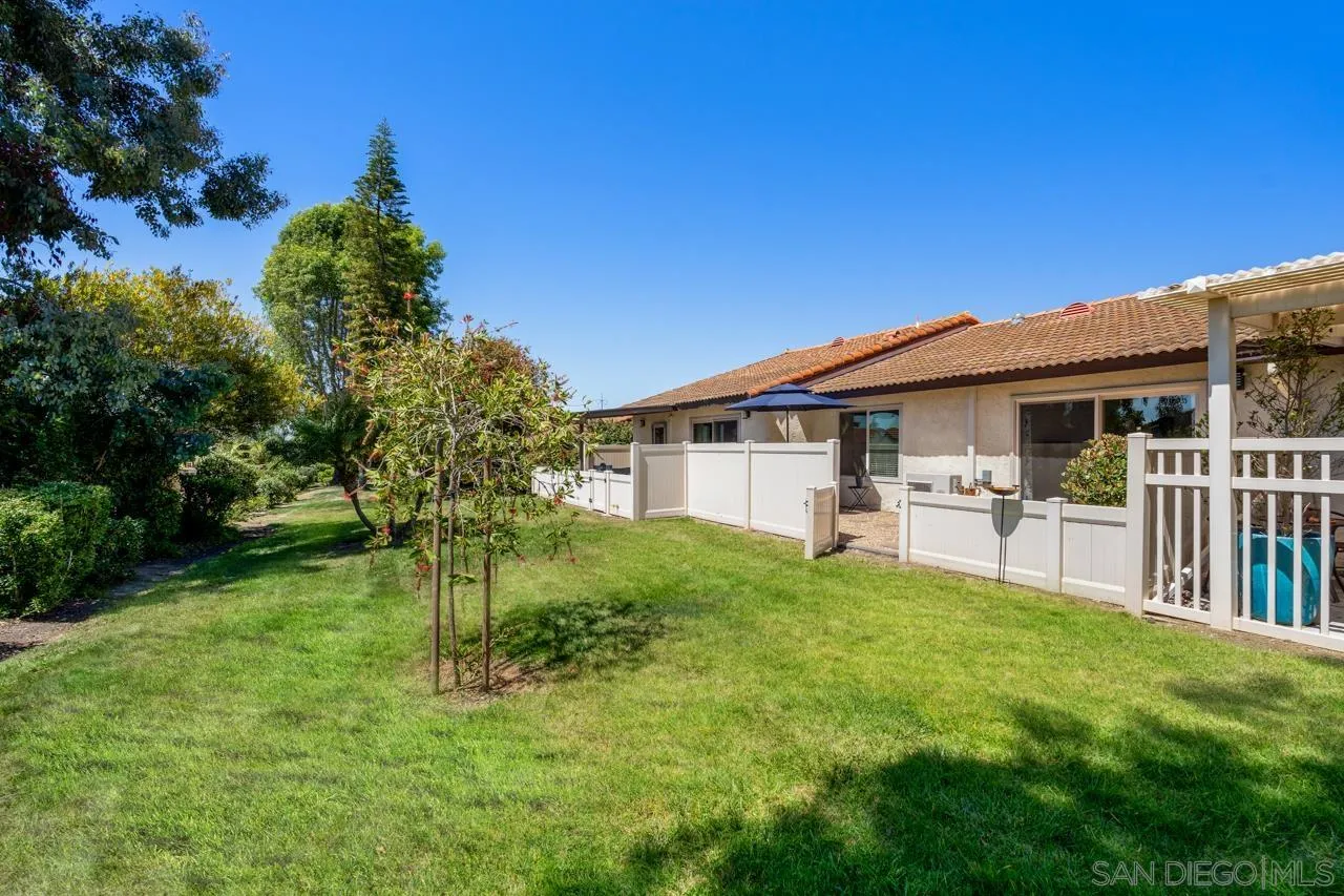 1628 Forestdale Drive Encinitas, CA 92024 - Photo 33 of 39 a white house that has a small yard and large trees