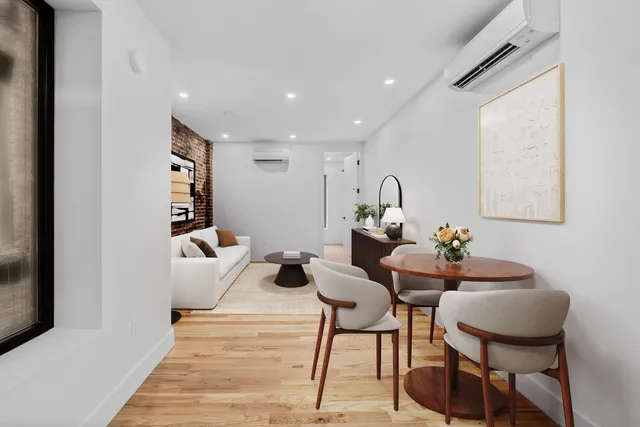 a living room with furniture a rug and a chandelier