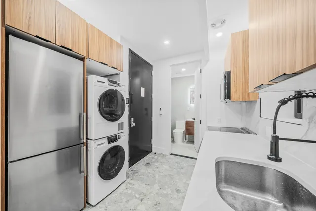 a kitchen with a sink and a refrigerator