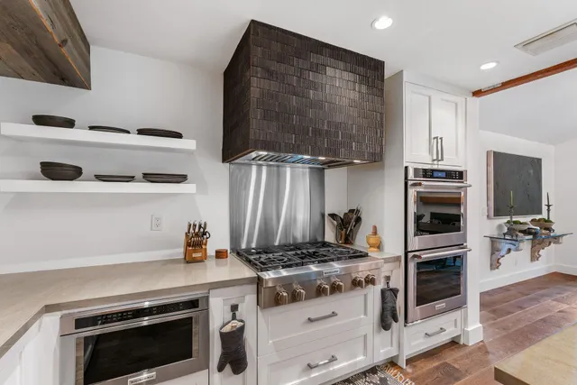 a spacious bedroom with a bed and a flat screen tv