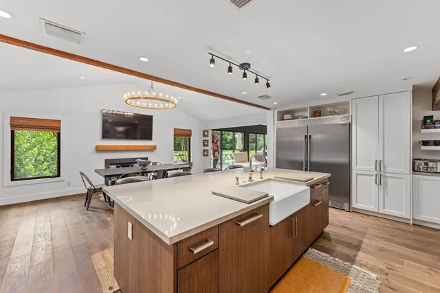 a bathroom with a granite countertop shower a mirror and a shower