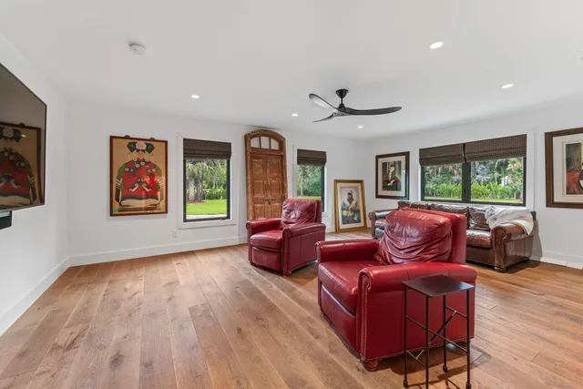 a bedroom with a large bed and a flat tv screen on dresser