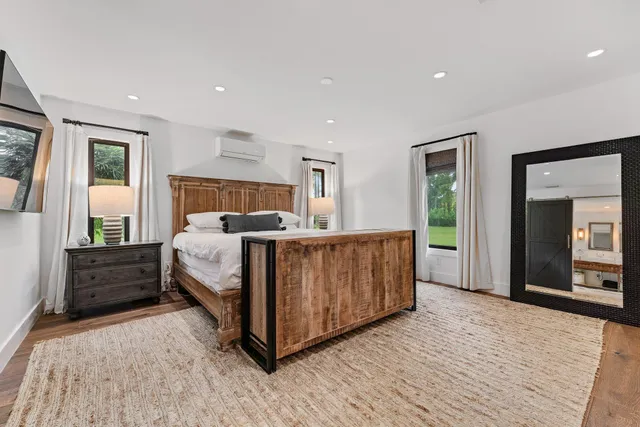 a bedroom with a bed and a large window