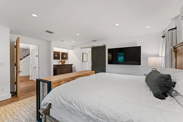 a bedroom with a bed and a flat screen tv