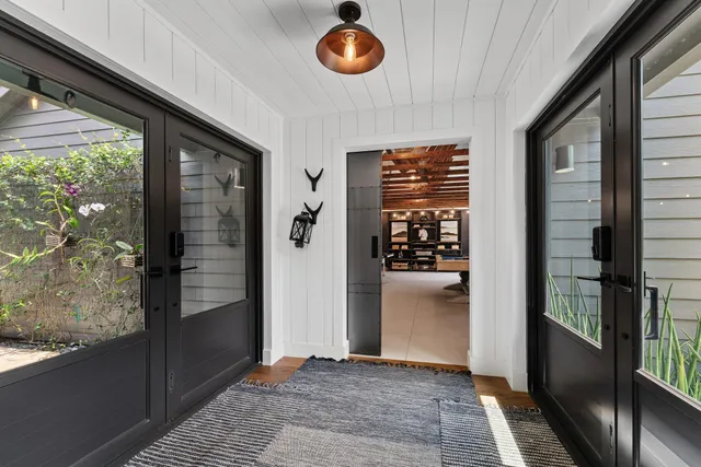 a bathroom with a granite countertop sink a mirror and shower