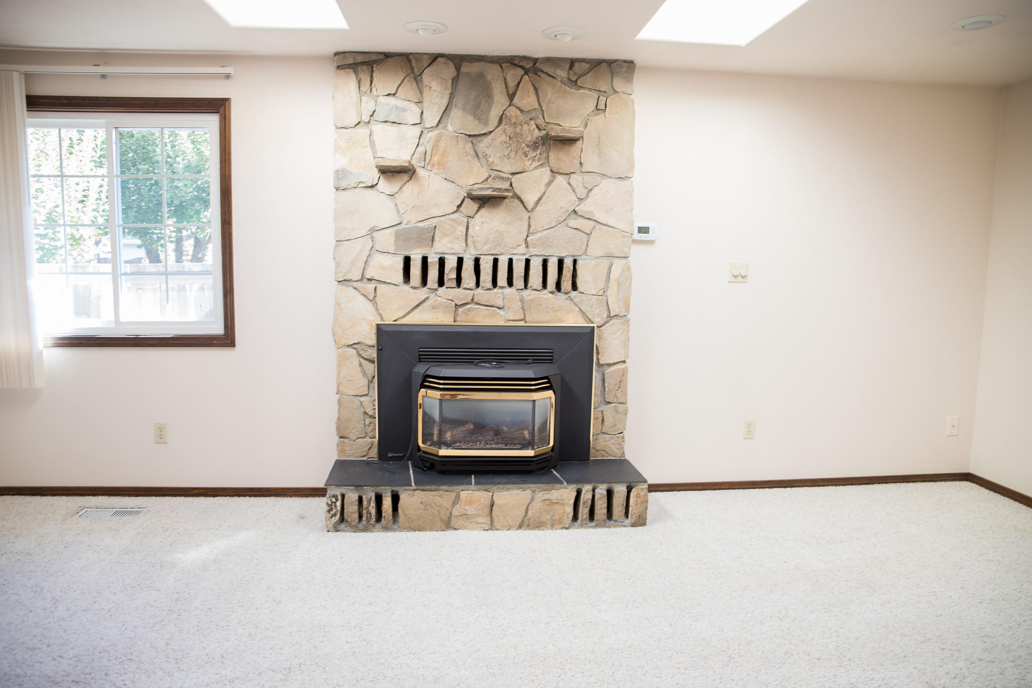 1992 Spring Street Medford, OR 97504 - Photo 14 of 37 Gas fireplace and skylights in living rm.
