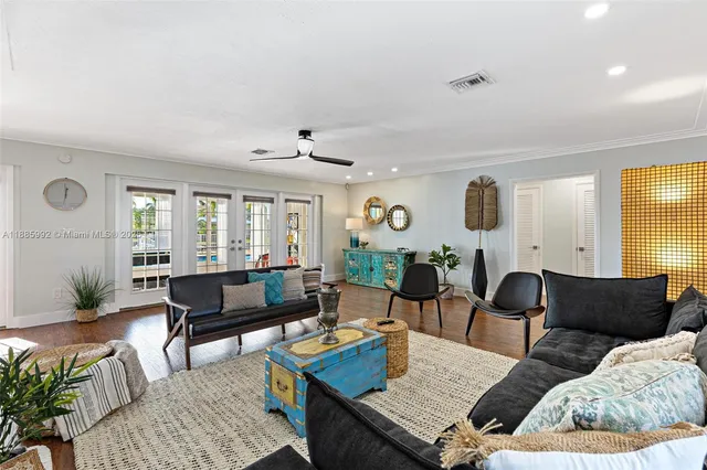 a living room with furniture and wooden floor