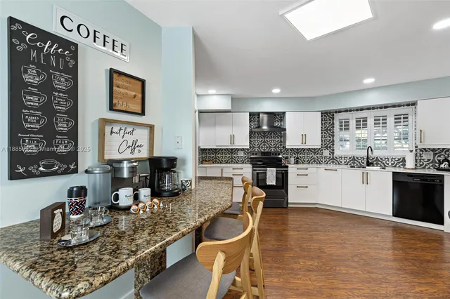 a kitchen with stainless steel appliances granite countertop a sink counter space and cabinets