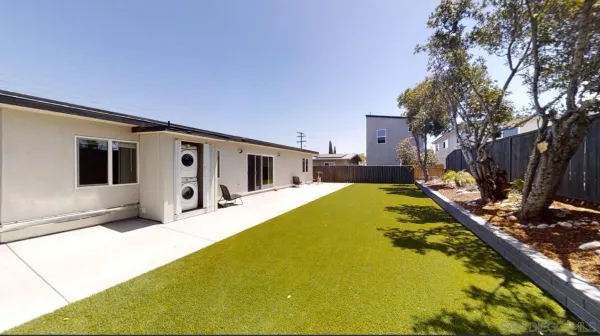 an aerial view of residential houses with outdoor space and parking