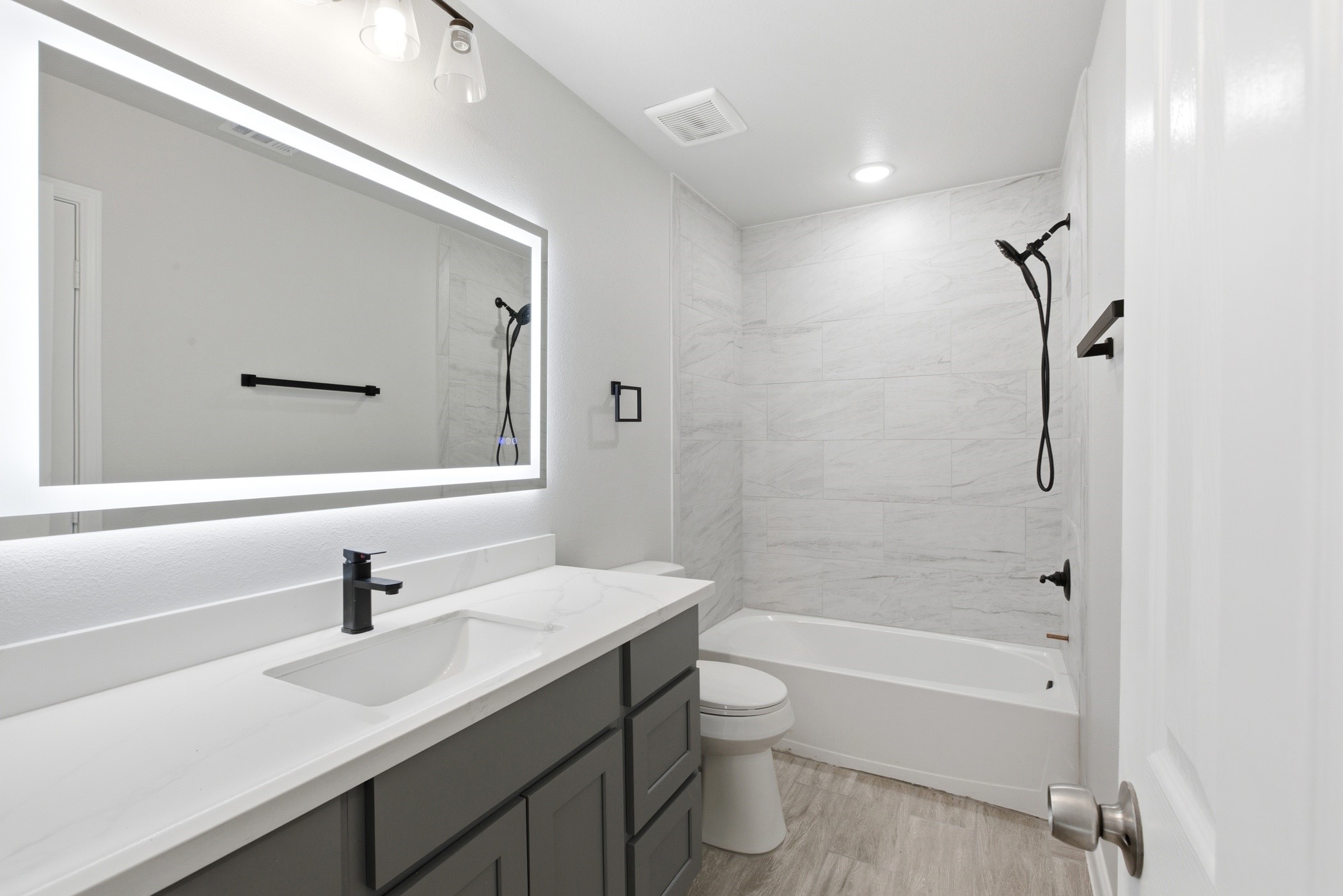 7310 Foxwaithe Lane Humble, TX 77338 - Photo 13 of 15 a bathroom with a sink mirror toilet and bathtub