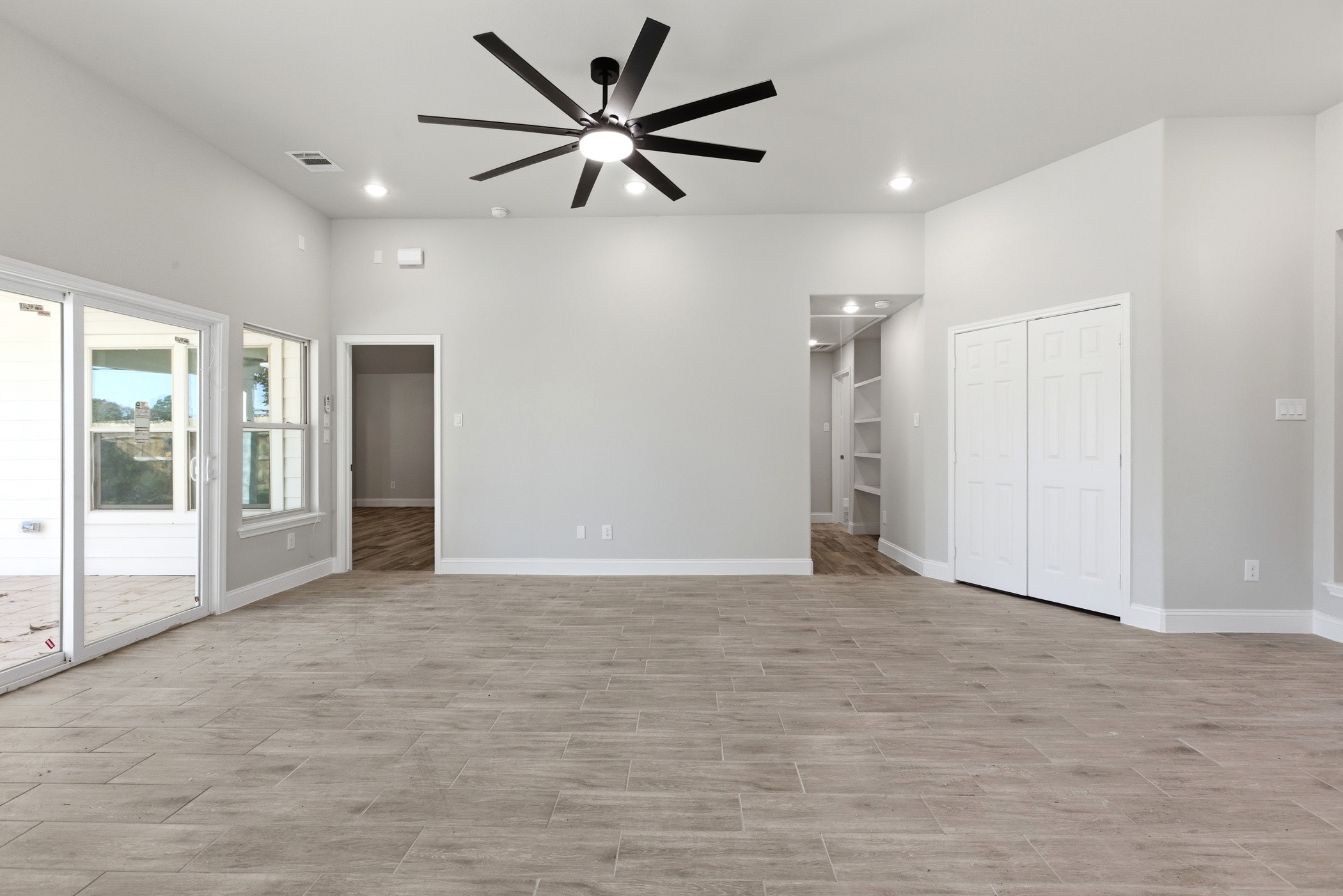 7310 Foxwaithe Lane Humble, TX 77338 - Photo 3 of 15 a view of an empty room with a ceiling fan