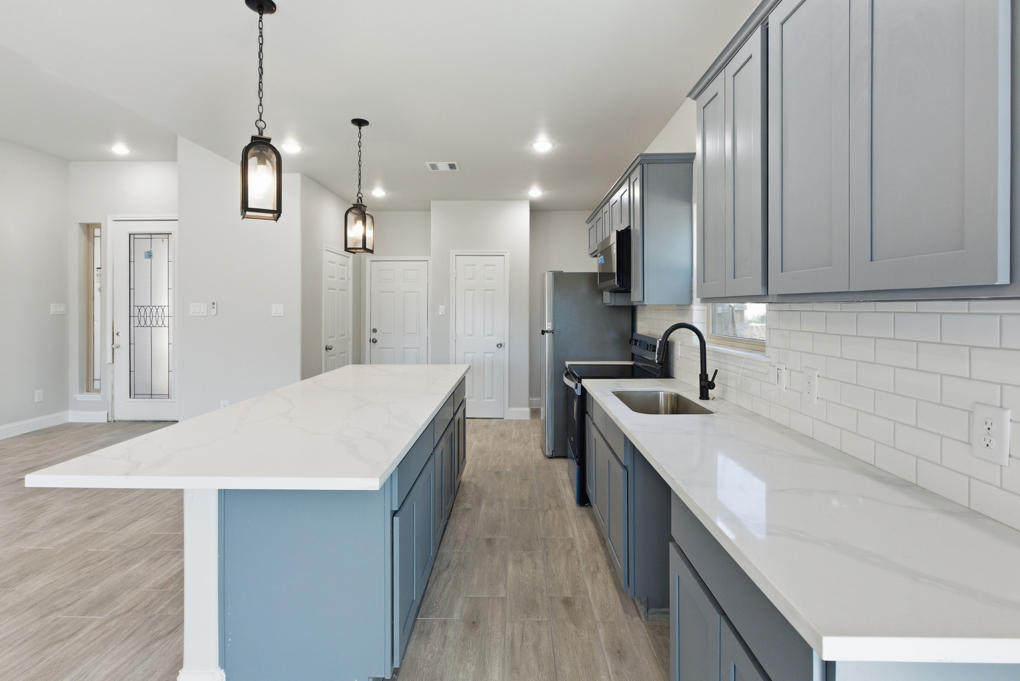 7310 Foxwaithe Lane Humble, TX 77338 - Photo 5 of 15 a very nice looking kitchen with kitchen island a sink a counter space and stainless steel appliances