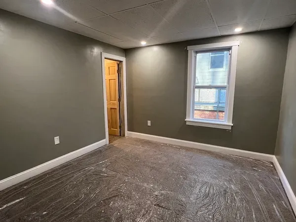 an empty room with windows and closet