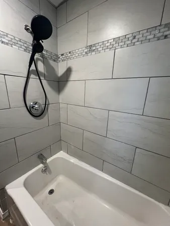 a bathroom with a shower and tub